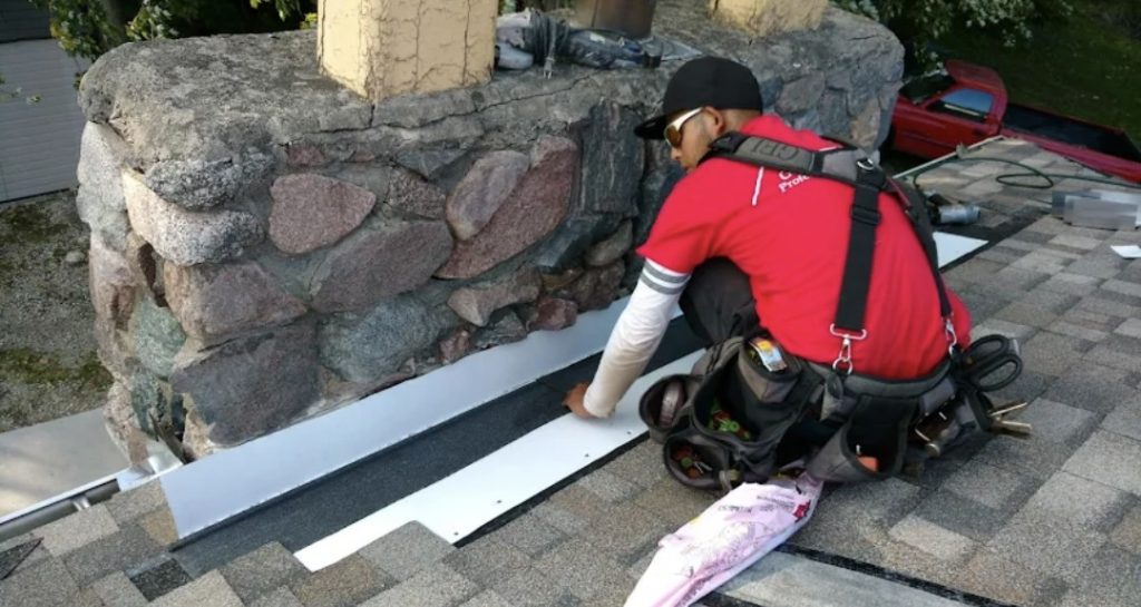 Gean Roofing team member performing roof repair service on a residential home.
