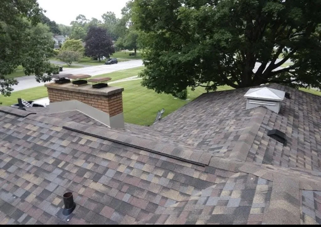Aerial view of a residential asphalt shingle roof in Michigan, highlighting roof areas inspected for potential storm damage by Gean Roofing.
